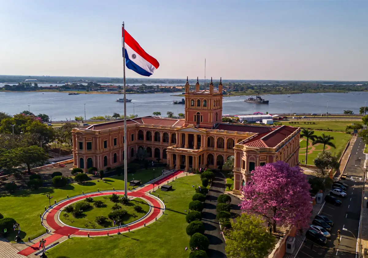Aerial view of the Palacio de López, seat of the Paraguayan government, on the banks of the Paraguay River in Asunción, with the national flag raised